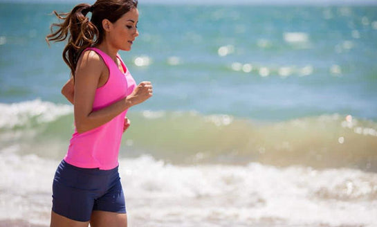 Woman jogging on the beach.